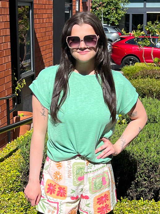 Green short sleeve ribbed tee with a relaxed fit and 3 wood button detail on shoulders.