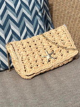 Woven handbag with star detail on a textured surface