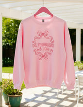 Pink sweatshirt with 'Ms. Fabulous' design on a hanger outdoors.