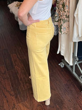 Person wearing yellow pants in a clothing store