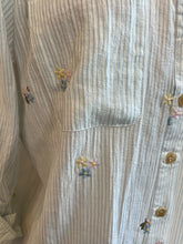 Close-up of a textured fabric with floral patterns on a wooden surface