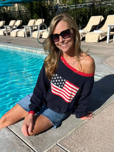 Woman in an American flag sweater by a pool