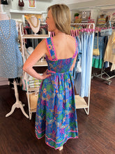 Woman wearing a colorful dress in a clothing store