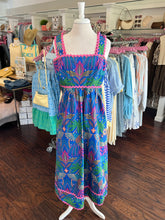 Colorful patterned dress on a mannequin in a clothing store.