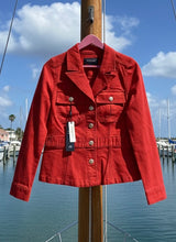 Red peplum jacket on a hanger with a marina background