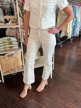 Person wearing a cream pant in a clothing store