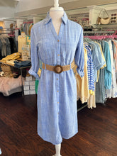 Blue shirt dress with a woven tan belt on a mannequin in a clothing store