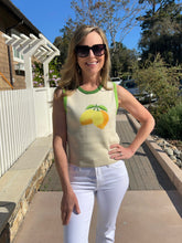 Woman wearing a sleeveless top with fruit design outdoors