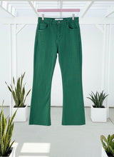 Green jeans handing on a patio