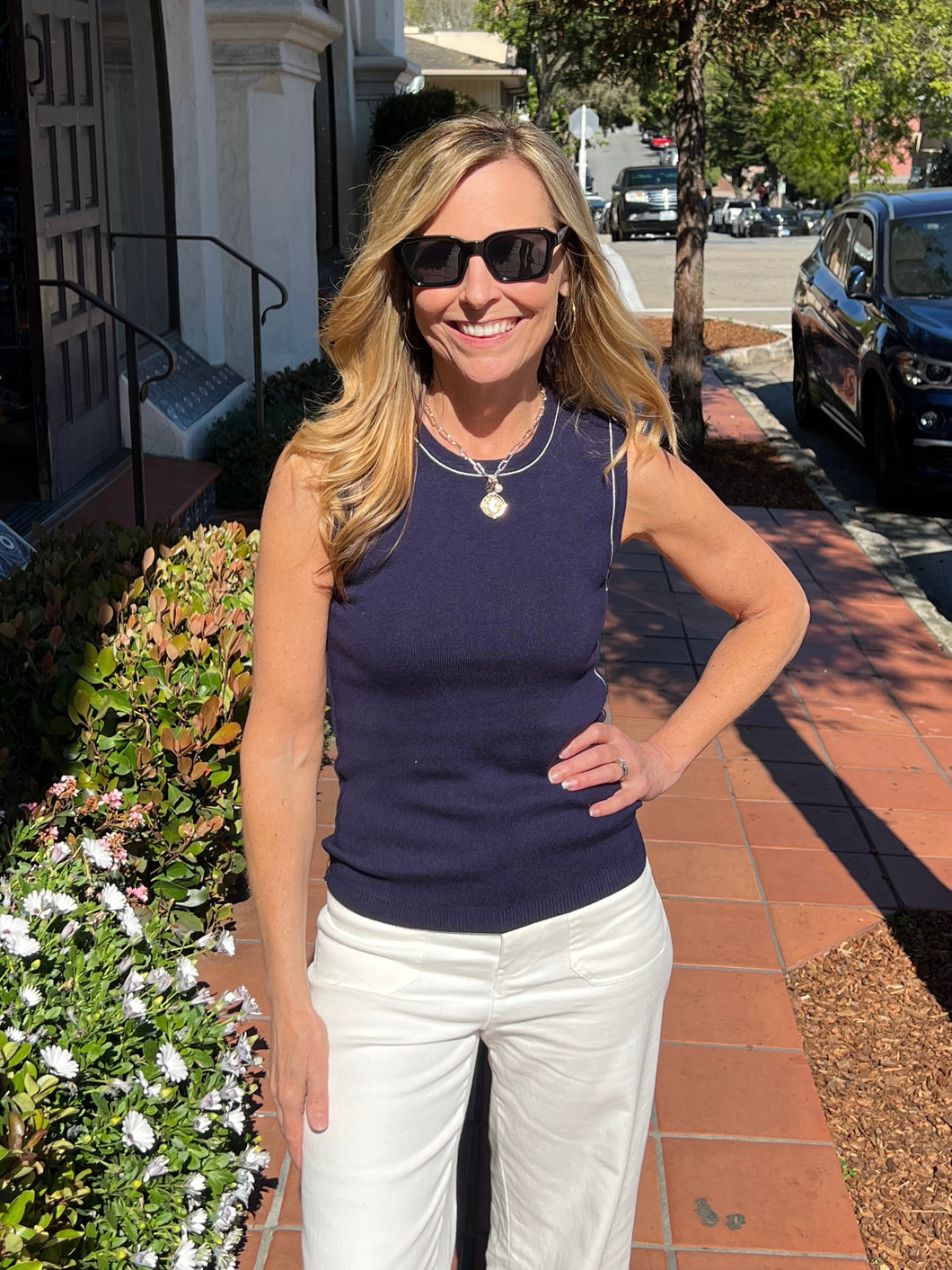 Navy crew neck sweater tank with a fitted look and white piping detail on the trim.