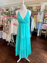 Turquoise dress on a mannequin in a clothing store
