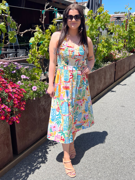 Halter style dress in a midi length, a fun colorful travel print and elastic waist. 