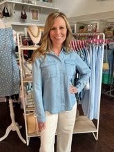 Woman wearing a denim shirt in a clothing store
