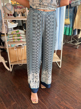 Person wearing patterned pants in a store setting