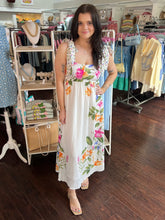 Woman wearing a floral dress in a clothing store