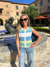 Woman standing in front of a fountain with architectural elements in the background