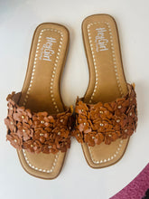Pair of brown floral sandals with 'Hey Girl' branding on a white background