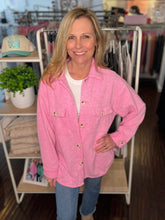 Woman wearing a pink jacket in a clothing store