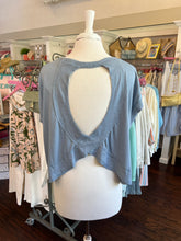 Blue tank top on a mannequin in a clothing store setting