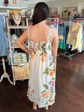 Woman wearing a floral dress in a clothing store