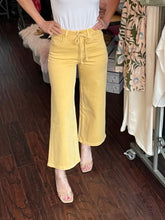 Person wearing yellow pants in a store setting