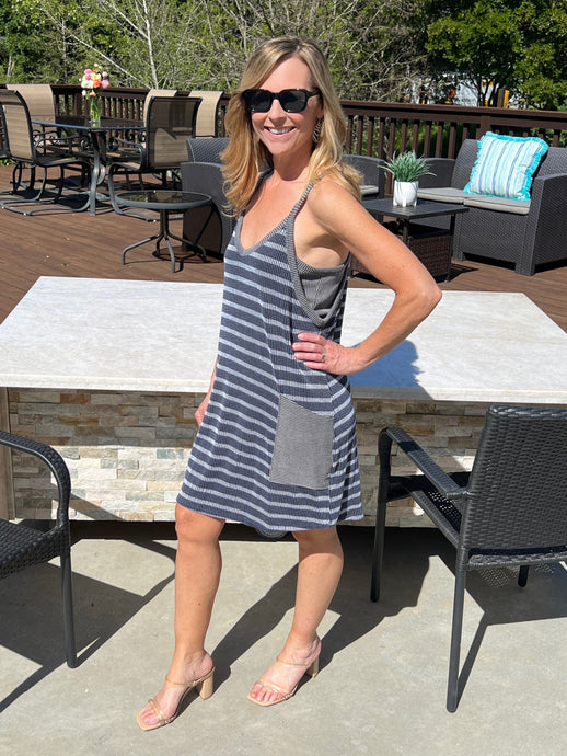 Grey knit stripe tank style romper mini dress with built in shorts underneath and wide patch pockets on the front.