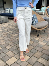 Person wearing white pants and a blue top on a patio