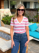 Woman wearing a red and white striped shirt and sunglasses outdoors
