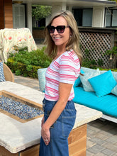 Woman wearing a red and white striped shirt and sunglasses outdoors
