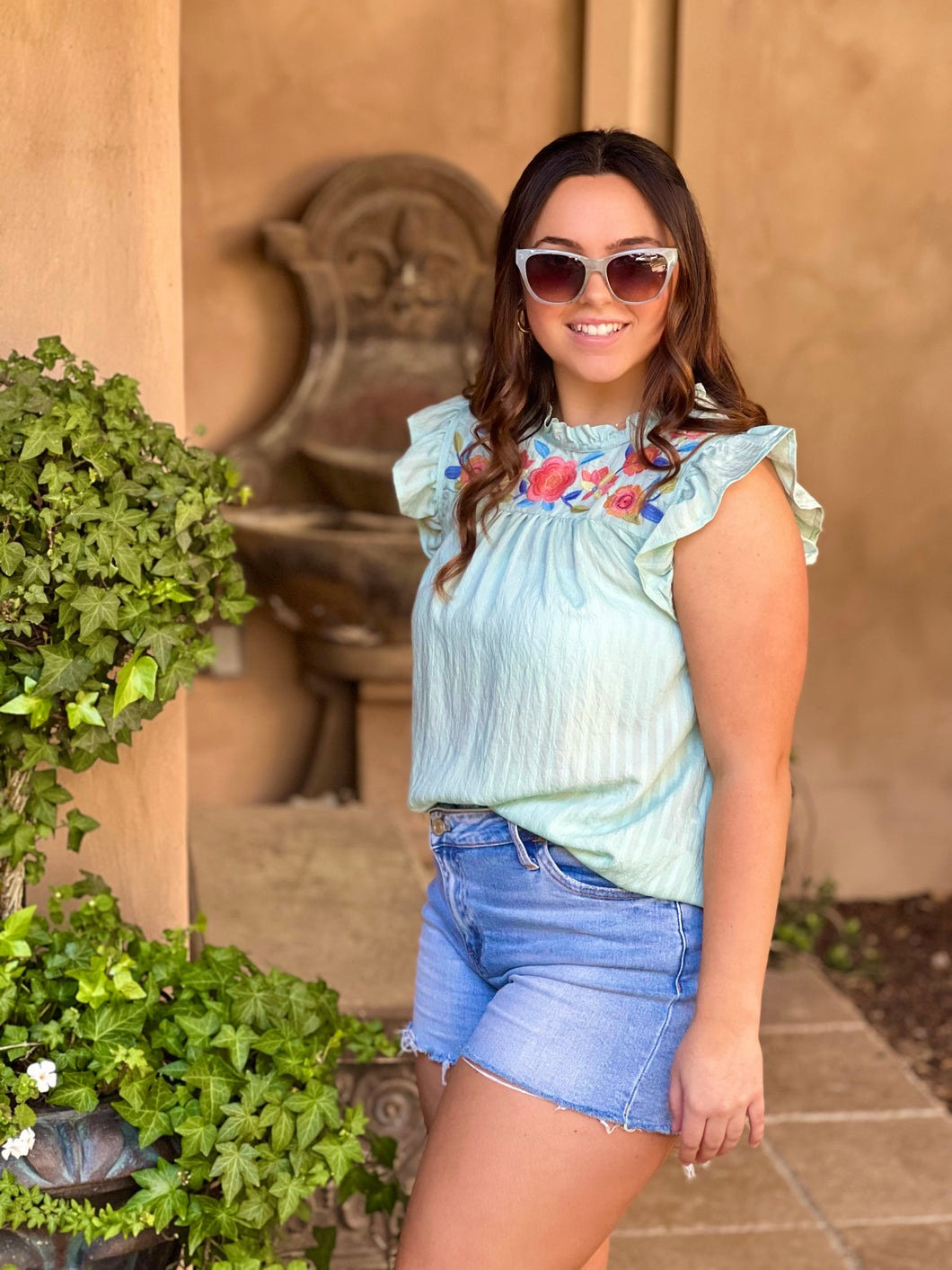 Women posing showing side view of shirt.