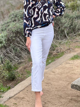 Close up of women wearing white pants, showing front view.